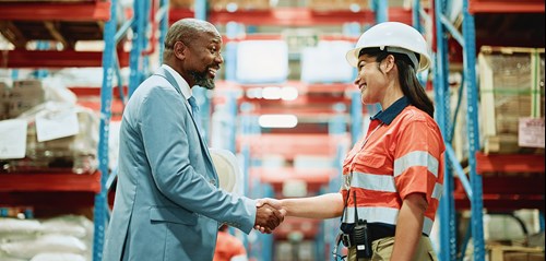 shaking hands in factory setting